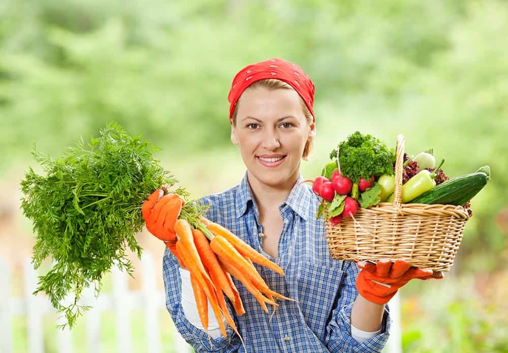 Women holding a selection of fresh vegetables